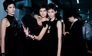 Female models dressed in the Emporio Armani A/W 2014 backstage of the fashion show