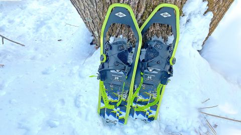 Atlas Range-MTN snowshoes resting against a tree in the snow