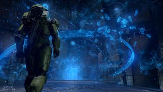 halo infinite screenshot with master chief in front of a damaged ring hologram