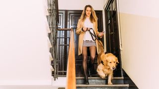 Woman walking down stairs with her dog