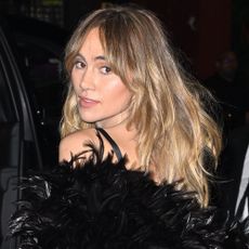 Suki Waterhouse looks over her shoulder