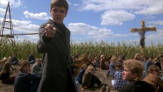 A child points menacingly out in a cornfield in 'Children of the Corn'