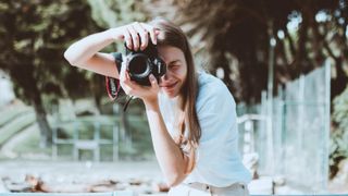 Woman holding the best camera for photography