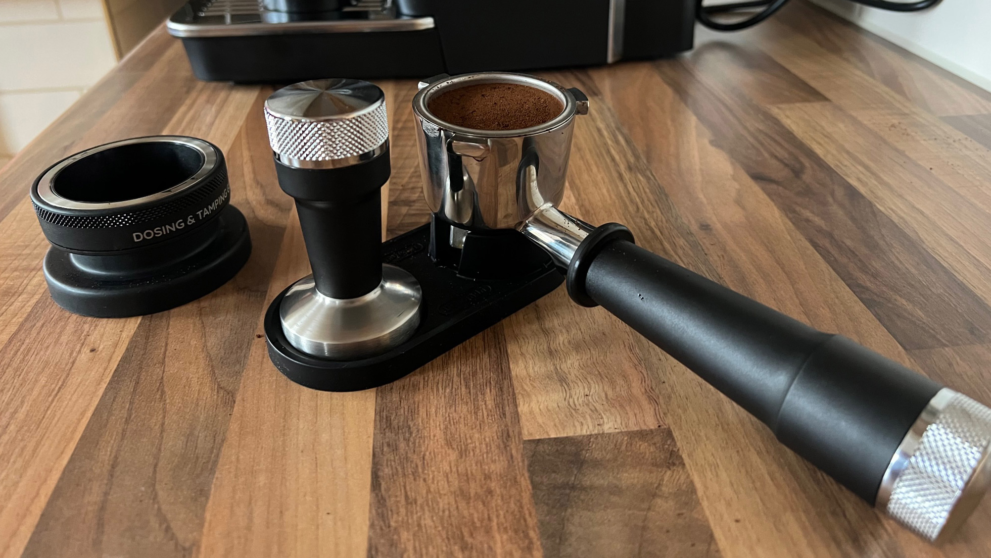 The tamp, tamping stand and dosing funnel that comes with the De’Longhi La Specialista Arte EC9155MB