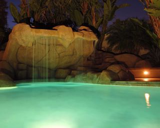 illuminated pool grotto at night