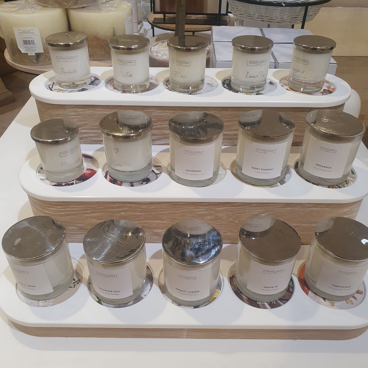 Scented candles from The White Company displayed on a stand at Selfridges