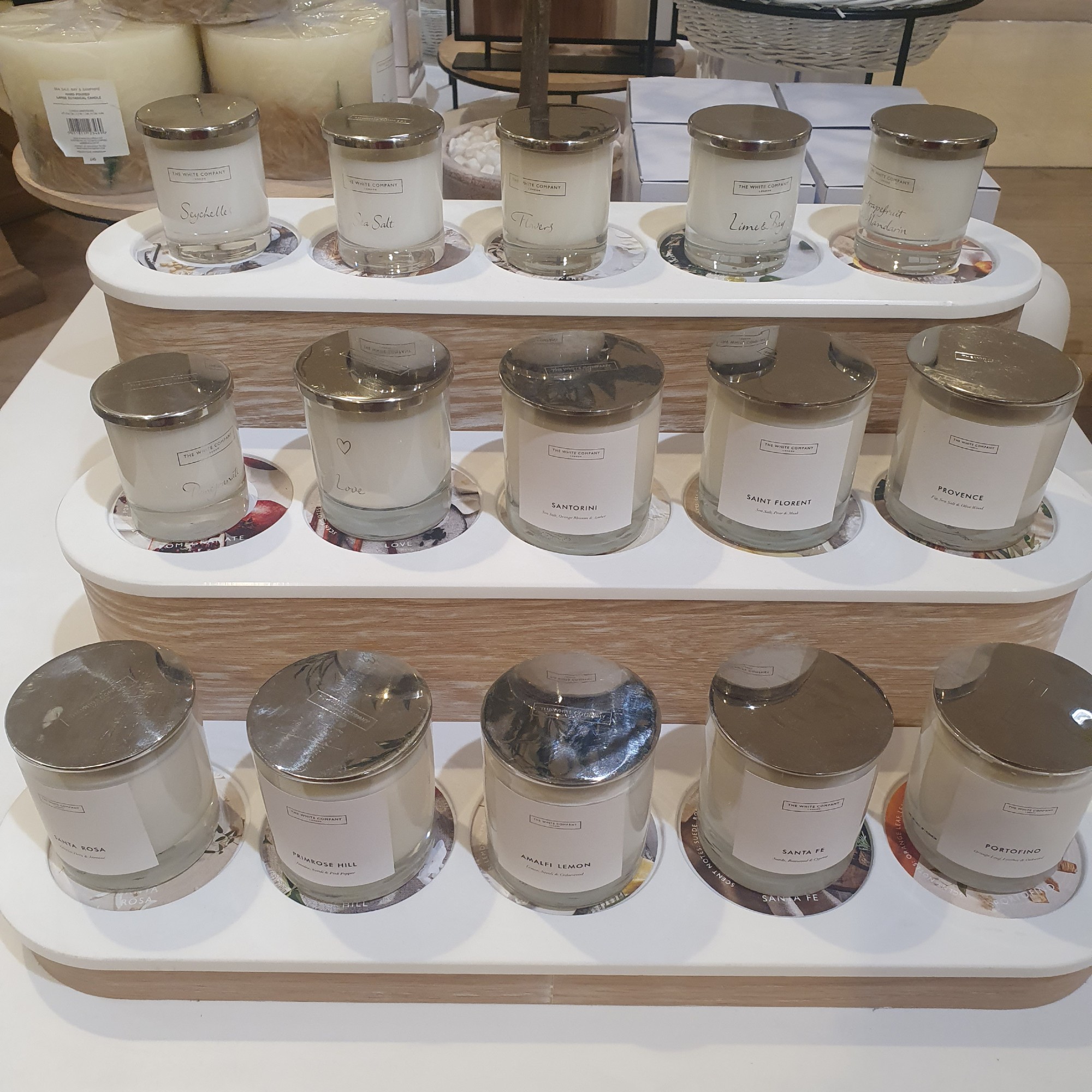 Scented candles from The White Company displayed on a stand at Selfridges