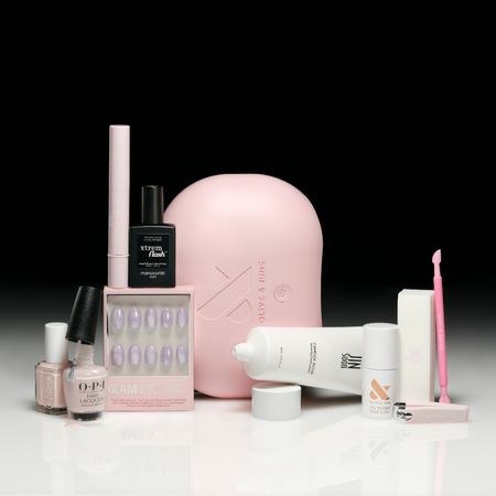 a selection of nail care products on a white ground with a black backdrop
