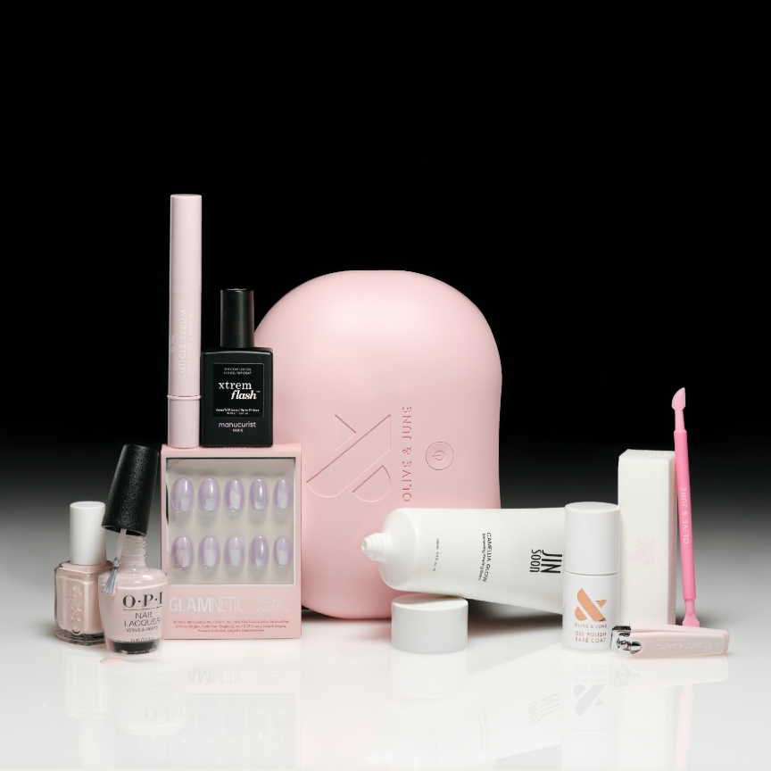 a selection of nail care products on a white ground with a black backdrop