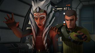 Still from 8. Star Wars Rebels Season 2 Episode 2: The Siege of Lothal Part 2. Here we see an older, more adult Ahsoka (orange skin, white face markings, 2 white head tails with blue stripes). She has her eyes closed and is holding her right hand up in front of her, palm facing forwards as she connects with the Force. Behind her, with a hand on her left shoulder, is Ezra Bridger. He has short dark brown hair and a small brown beard. Like Ahsoka, he also has his eyes closed and one of his hands up, palm facing forwards.