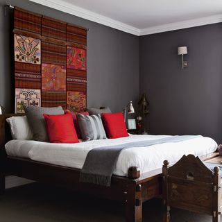 bedroom with grey wall and wooden furniture
