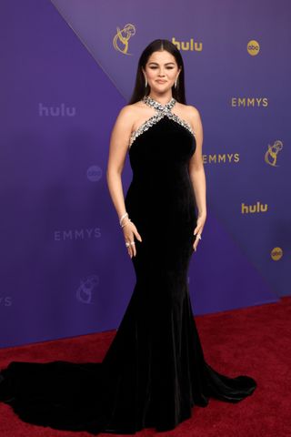 Selena Gomez wears a black maxi dress with a crystal-embellished design.