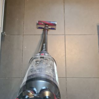 Dyson Micro 1.5kg being used on tiles