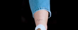 Danielle Harold's EastEnders tattoo on the back of her ankle. The tattoo is of the River Thames shape seen in the opening title sequence of EastEnders.
