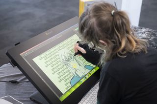 Vertex 2024; a woman draws on a digital tablet