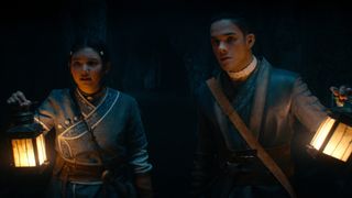 Sokka and Katara hold up lanterns in a dark cave in Avatar: The Last Airbender