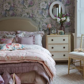 bedroom with floral wallpaper and mirror on wall