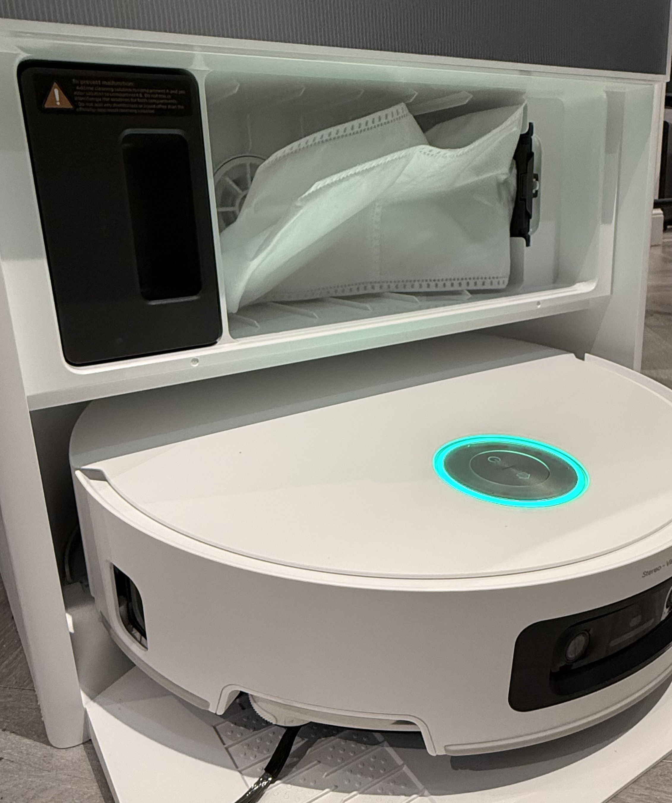 Inside view of the Dreame Aqua10 Ultra Roller dock showing the dust bag and internal storage compartment