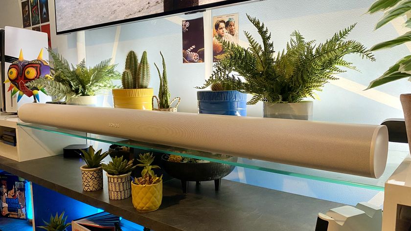 The Sonos Arc Ultra in a living room, in front of plants and personal niknaks