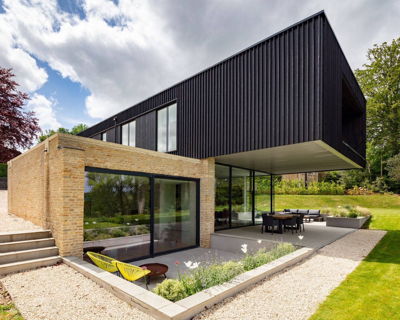 cantilevered self build with outdoor dining area below