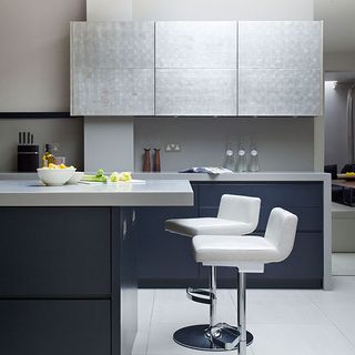 kitchen room with white tiled flooring and kitchen cabinets