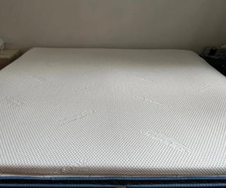 The Tempur-Pedic Tempur-Adapt Topper on a bed.