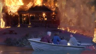 People escape in a boat from a burning house in Dante's Peak.