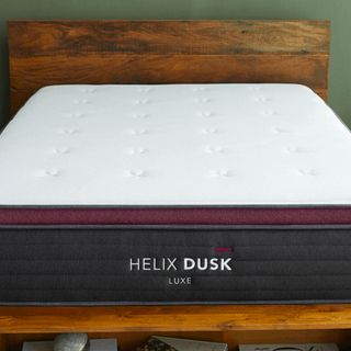 Helix Dusk Luxe Mattress against a green wall.