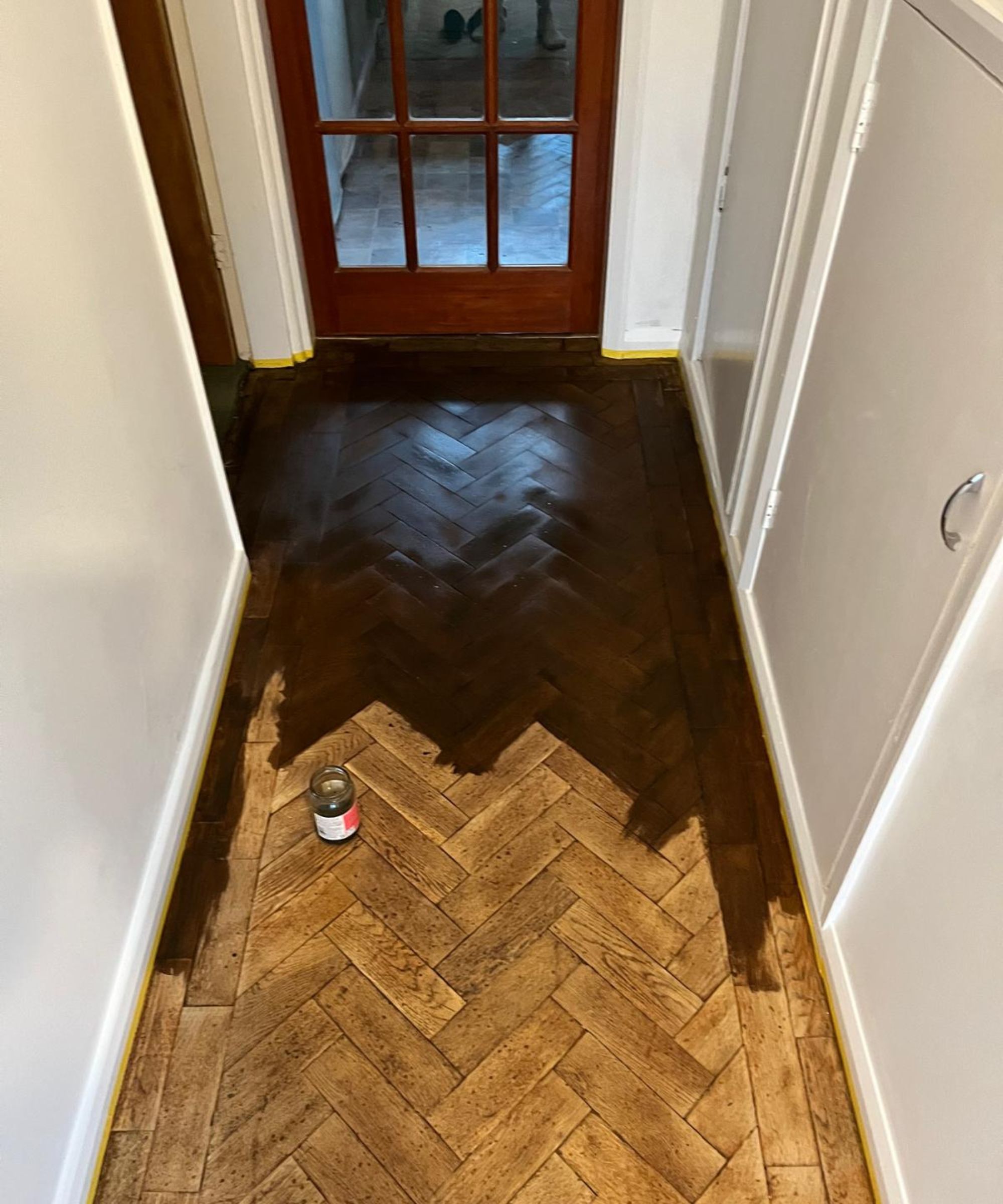 A vintage parquet floor being renovated via sanding and the application of wood dye