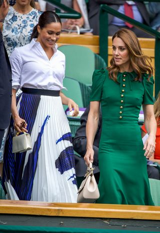 Meghan, Duchess of Sussex walks into the Royal Box on Centre Court at Wimbledon