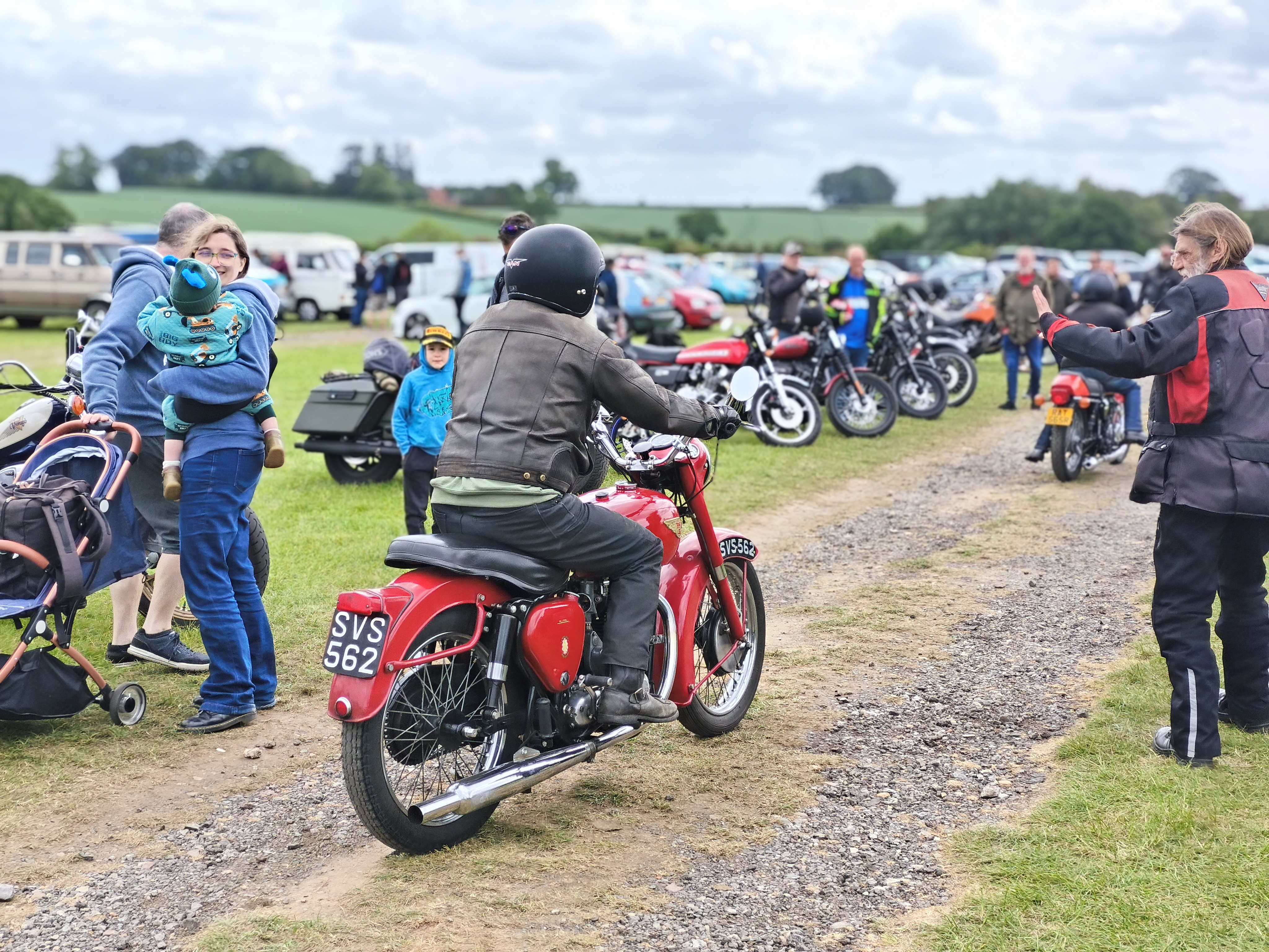 Person riding a motorbike through a crowd of people