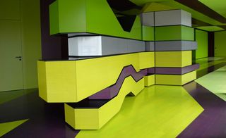 Interior room, Black, yellow, silver and bright green angular contour line designed floor, ceiling and walls, entrance door to the left