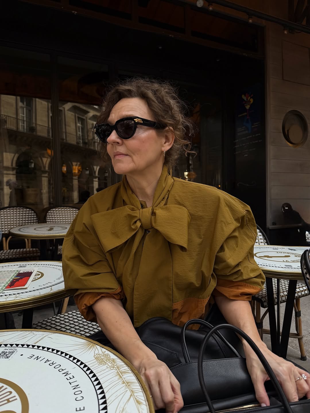 Renia in khaki top with a bow