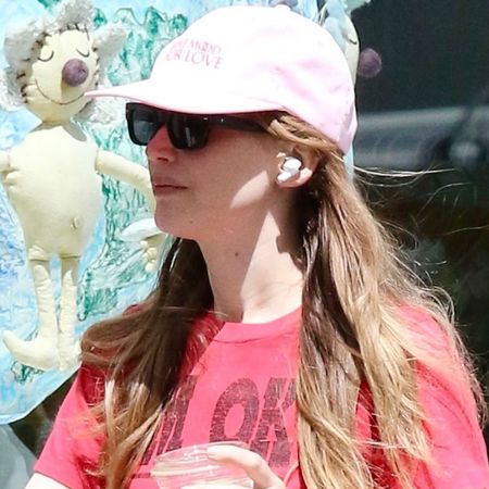Jennifer Lawrence wore the strawberry red and peony pink color trends with dad sandals for summer