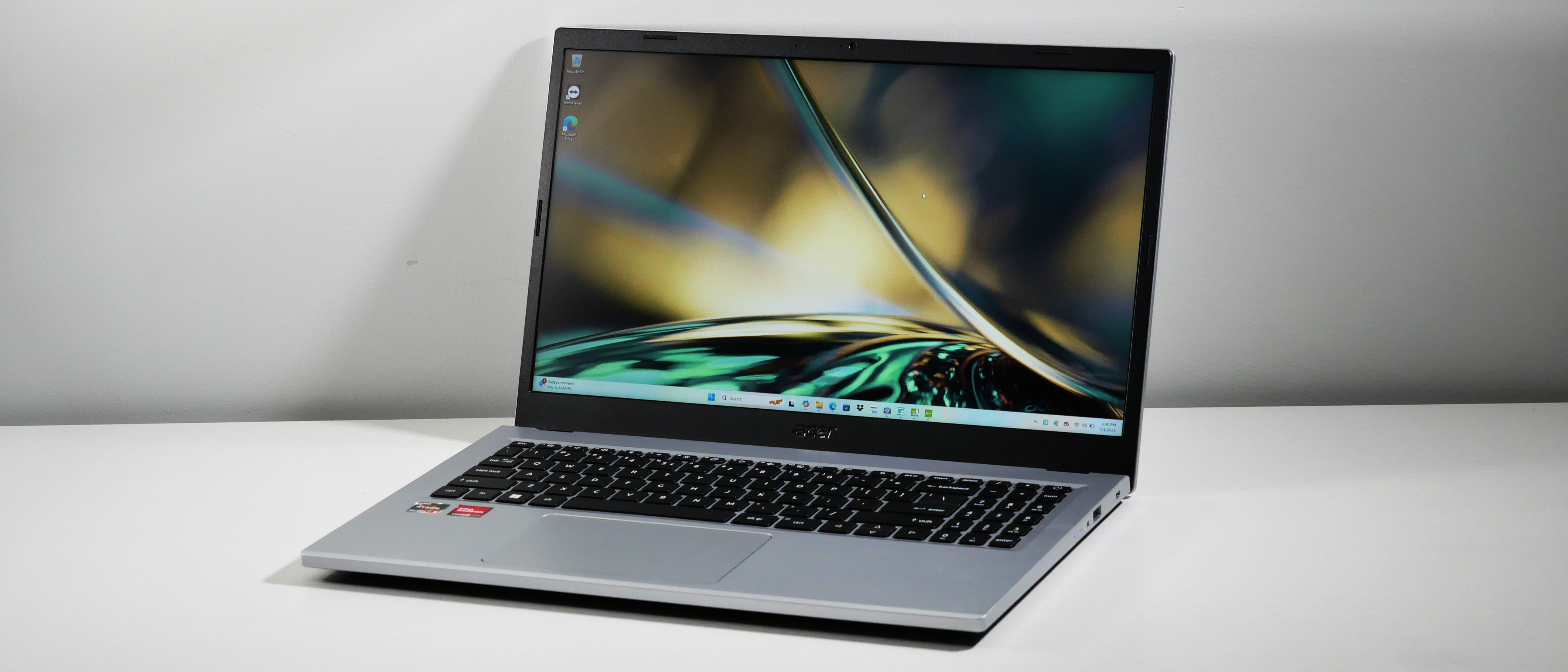 Acer Aspire 3 15 open at an angle on a white desk.