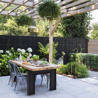 Wooden pergola covering an outdoor seating area
