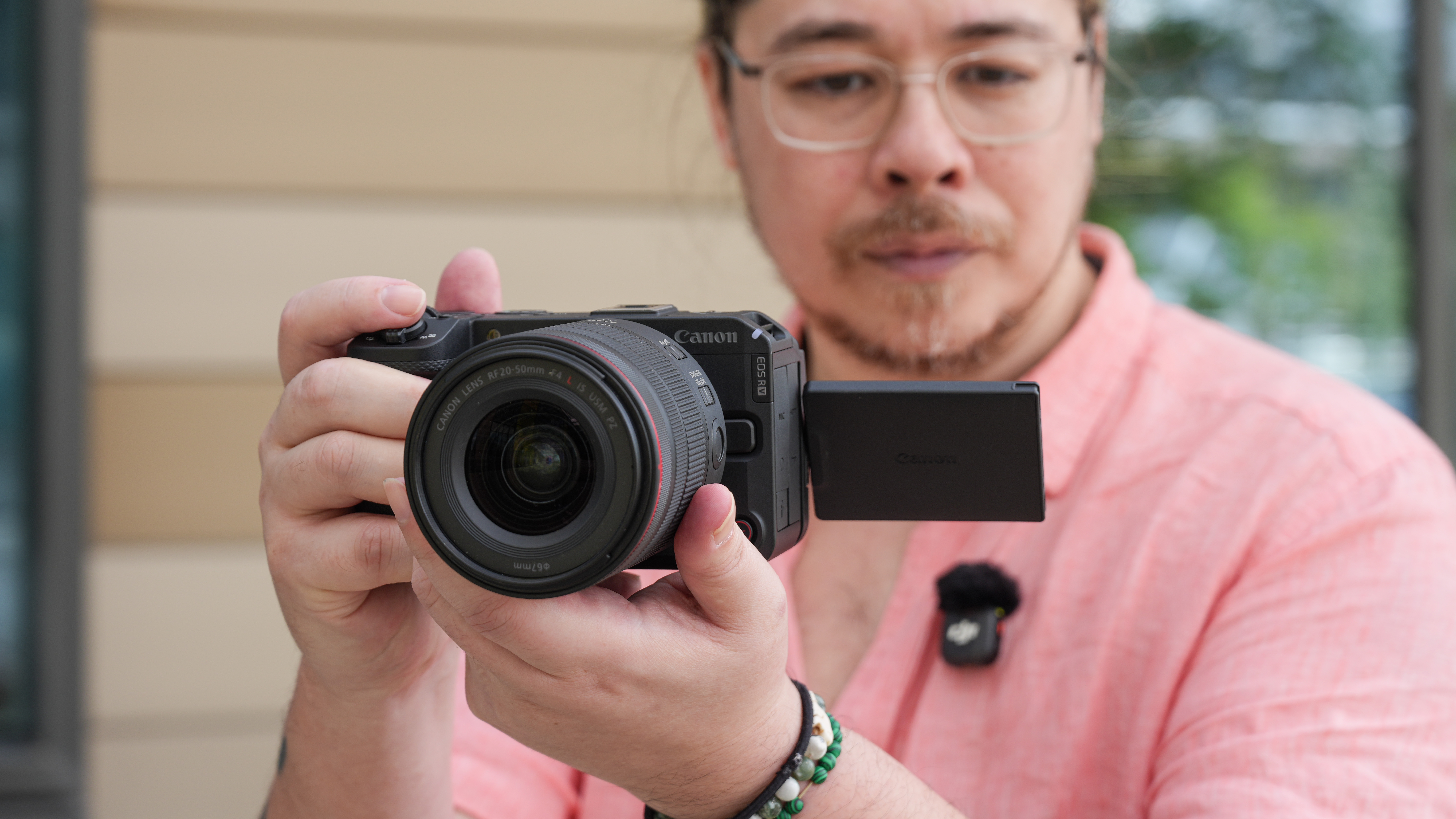 Canon EOS R6 V with the Canon RF 20-50mm f/4L IS USM PZ being held by James Artaius