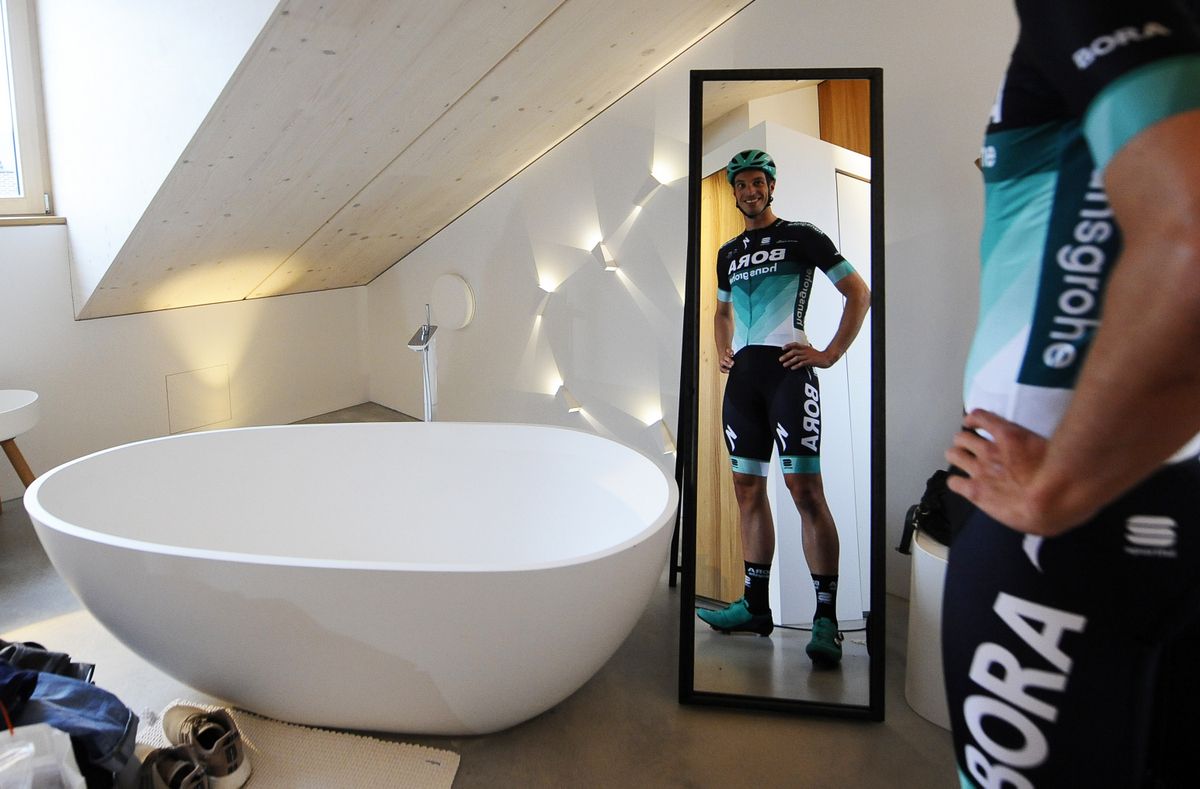 Rudi Selig models the kit before the team presentation