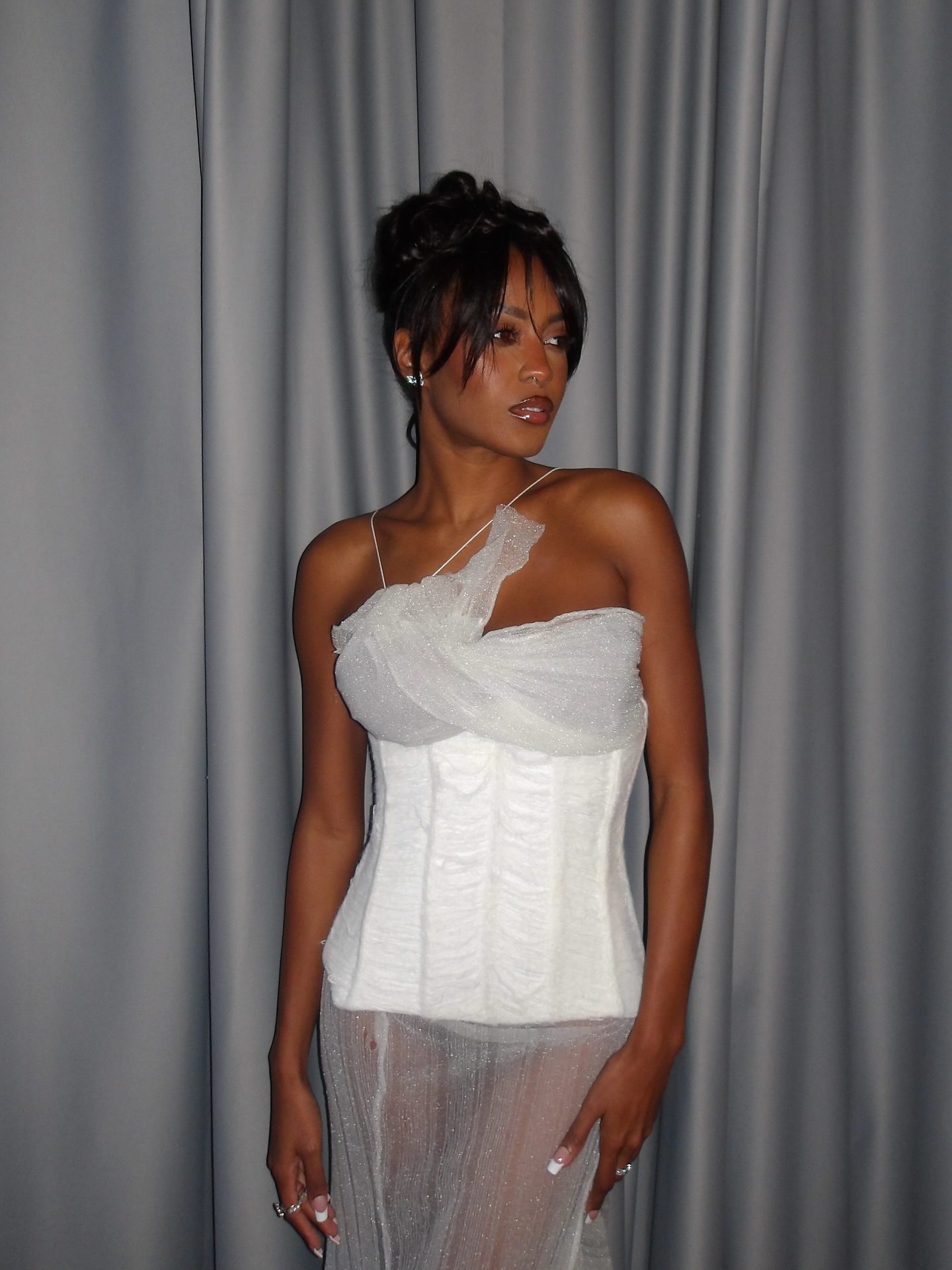 Ciara Miller wearing and chic updo and bronzed makeup look