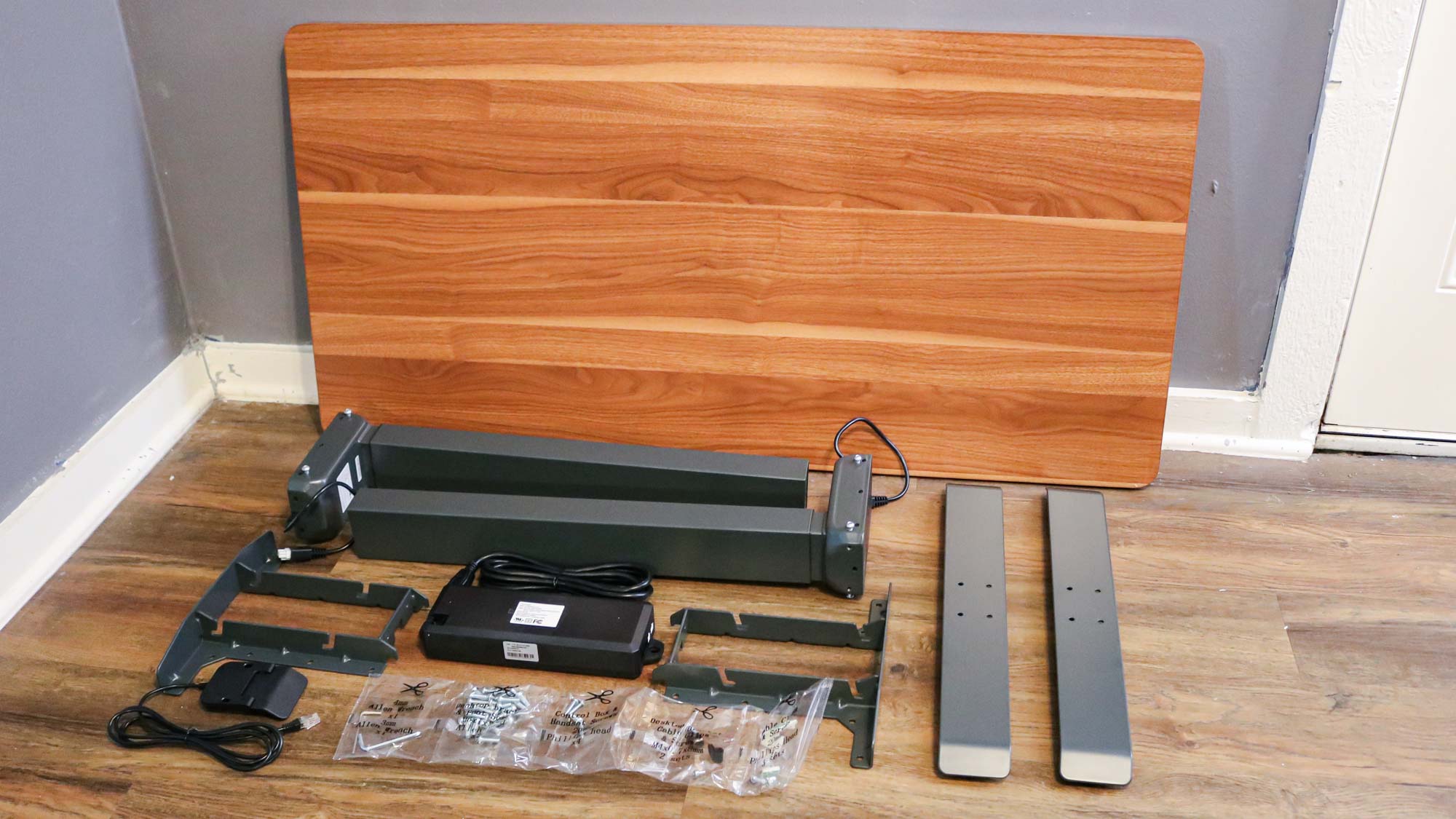 All of the pieces needed to build the Branch Duo Standing Desk laid out on the floor