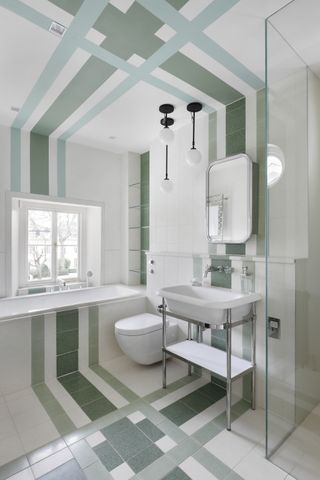 Small bathroom tile ideas example with green and white floor tiles laid up the bath tub and wall.