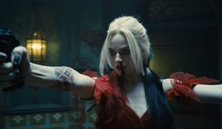 Harley Quinn aims a gun while clearing a room in The Suicide Squad.