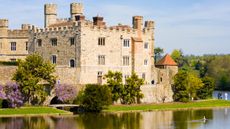 Traditional English castle with moat on a sunny day
