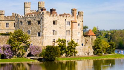 Traditional English castle with moat on a sunny day