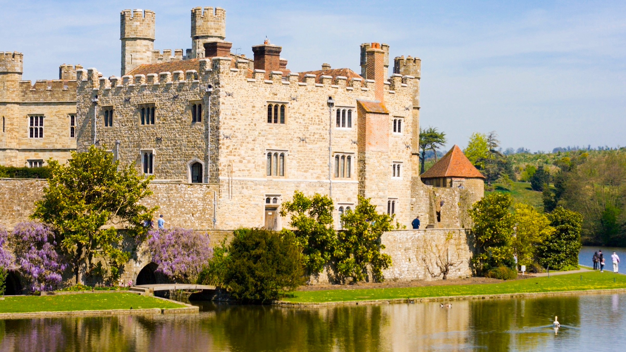 Traditional English castle with moat on a sunny day