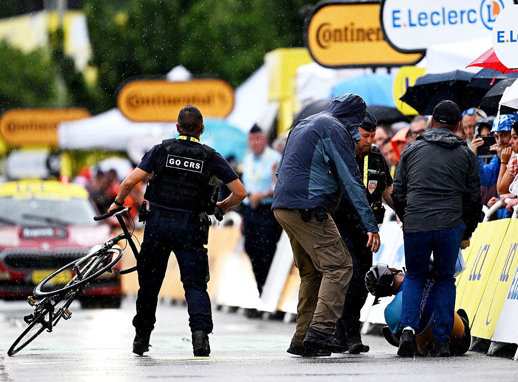 A French Republican Security Corps (CRS - Compagnies Republicaines de Securite) officer tackles an individual attempting to cycle across the finish line minutes before the final sprint of the 112th edition of the Tour de France cycling race, 160.4 km between Bollene and Valence, southern France, on July 23, 2025. (Photo by Marco BERTORELLO / AFP)