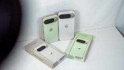 A jade Google Pixel 10 Pro and a white Google Pixel 10 Pro XL with their respective boxes