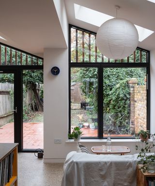 Stunning glazing in a kitchen extension. with roof lights and a large window and doors looking out to a garden