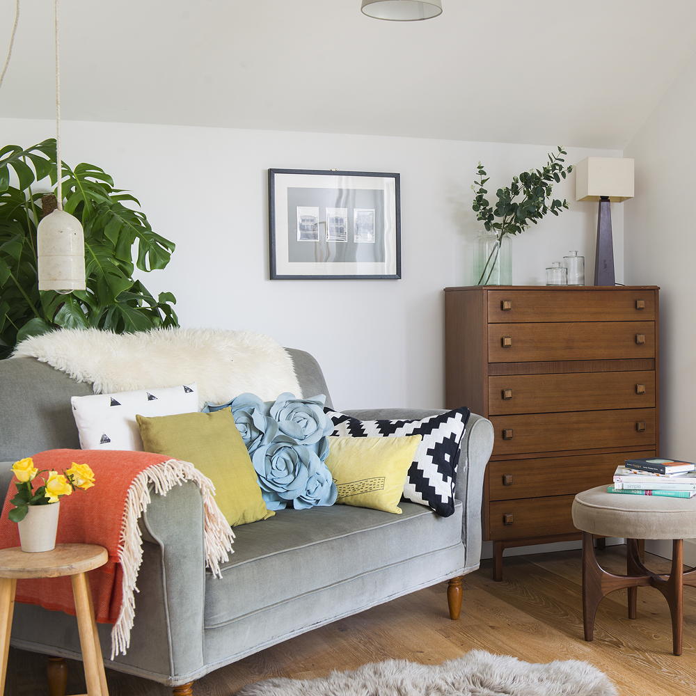 living room with white wall and grey sofa