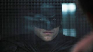 Robert Pattinson scowls on the other end of the glass at Arkham in The Batman.